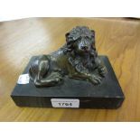 Brown patinated bronze figure of a recumbent lion , mounted on a slate base, 6ins x 4ins x 4ins high