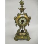 Ornate late 19th Century brass mantel clock with ceramic dial and Roman numerals, with a single