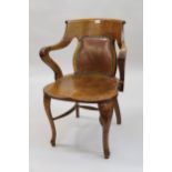 Early 20th Century oak office armchair, having bow back with leather pad and shaped wooden seat on