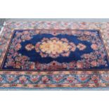 20th Century Kirman part silk rug with a lobed floral medallion and stylised floral design on a