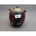 William Moorcroft biscuit barrel decorated with pansies on a blue ground, having pewter mount with