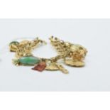 14ct Gold charm bracelet mounted with various charms including two 18ct, seven 14ct and seven