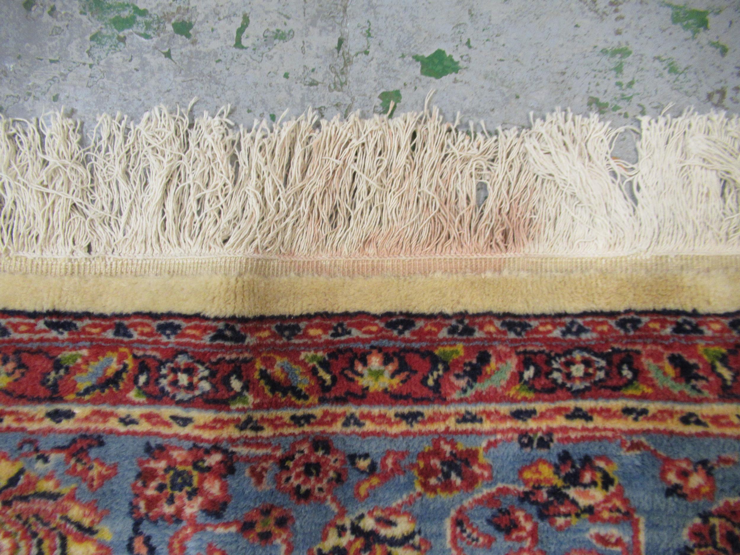 Indian carpet with an all over stylised floral design on ivory ground with pale blue borders, 140ins - Image 4 of 6