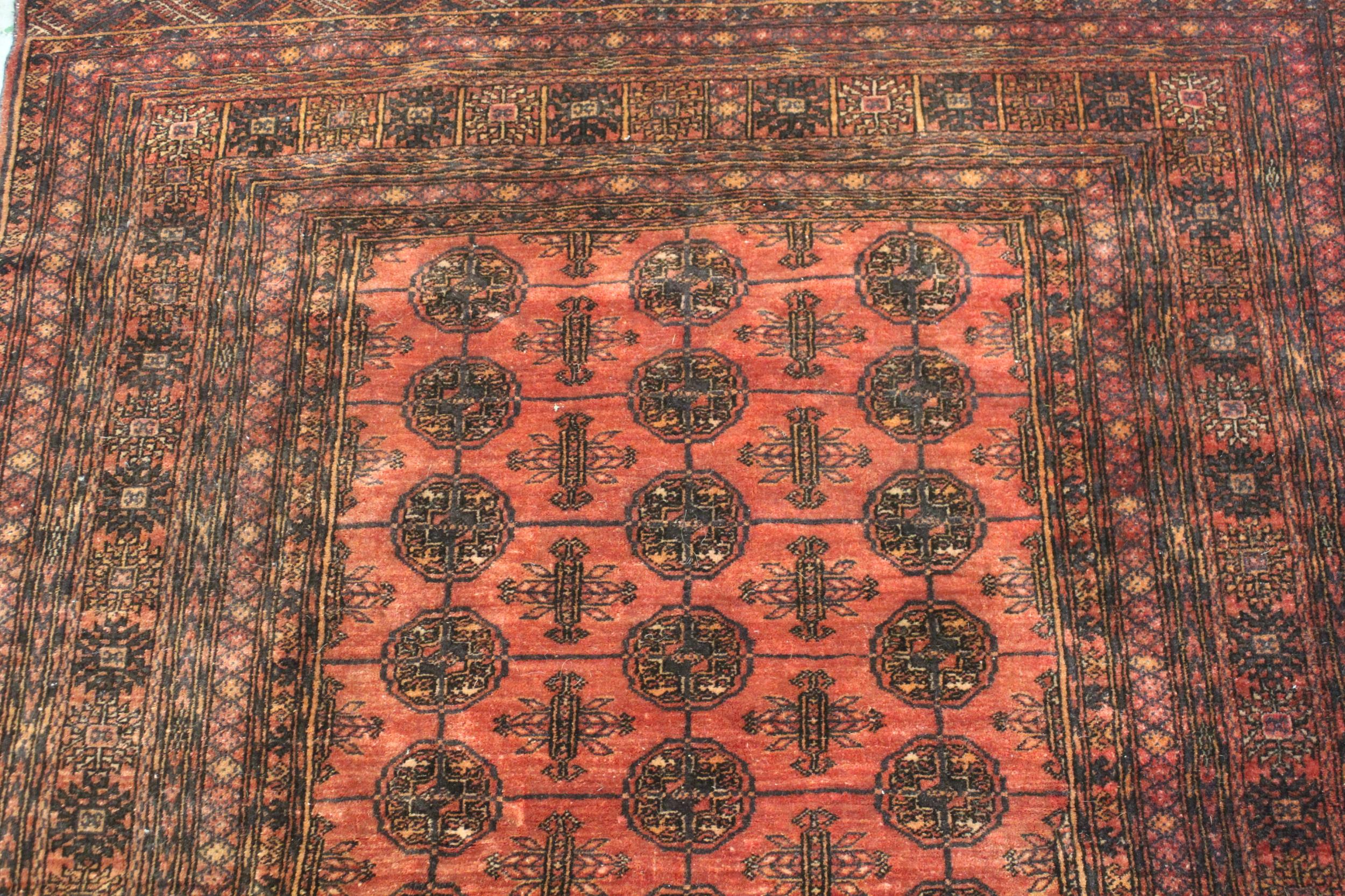 Modern Turkoman rug with three rows of ten gols on a wine ground, with multiple border, 6ft x 4ft - Image 2 of 4