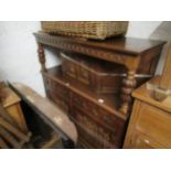 Reproduction oak court cupboard, canopy top with single panelled door, having carved decoration