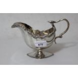 Birmingham silver shell shaped cream jug, with stylised C-scroll handle in the form of a serpent,