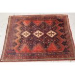 Afghan rug with a triple hooked medallion design on a red and blue ground with multiple borders, 7ft