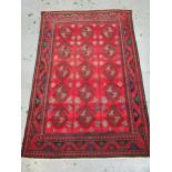 Modern Belouch style rug with an all over hooked medallion and panel design on a red ground with