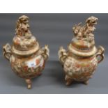 Pair of late 19th Century Satsuma two handled vases, the covers mounted with dogs of foe,