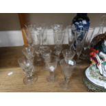 Eleven glass champagne flutes, and other antique glassware