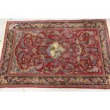 Qum rug with a pictorial centre medallion and all over stylised floral design on wine red ground