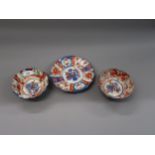 Two Japanese Imari pattern bowls and a similar plate