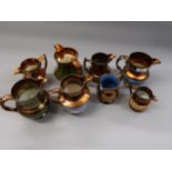 Collection of various copper lustre jugs