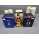 Five boxed Bell's Scotch Whisky, ceramic decanters and an unboxed Bell's ceramic decanter, all