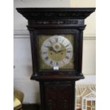 George III carved oak longcase clock, the square hood above a rectangular panelled door on a