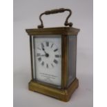 20th Century gilt brass cased carriage clock, the enamel dial with Roman numerals, with key,