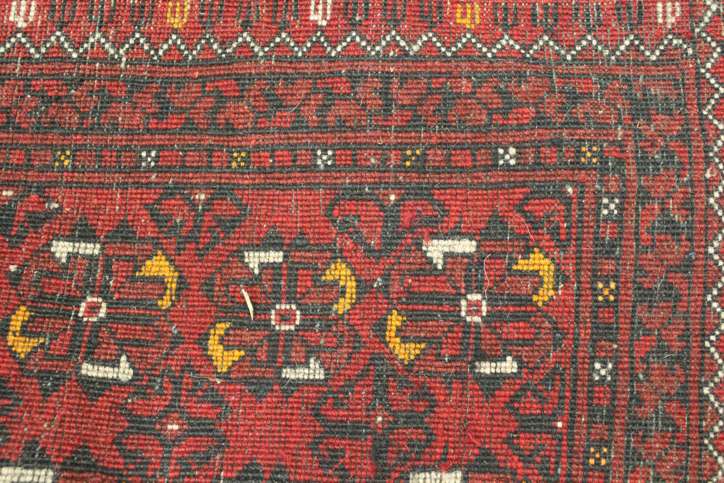 Afghan runner with four rows of gols, on a deep red ground with borders, 9ft 3ins x 2ft 8ins - Image 3 of 3