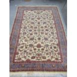 Indian carpet with an all over stylised floral design on ivory ground with pale blue borders, 140ins