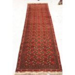 Afghan runner with four rows of gols, on a deep red ground with borders, 9ft 3ins x 2ft 8ins