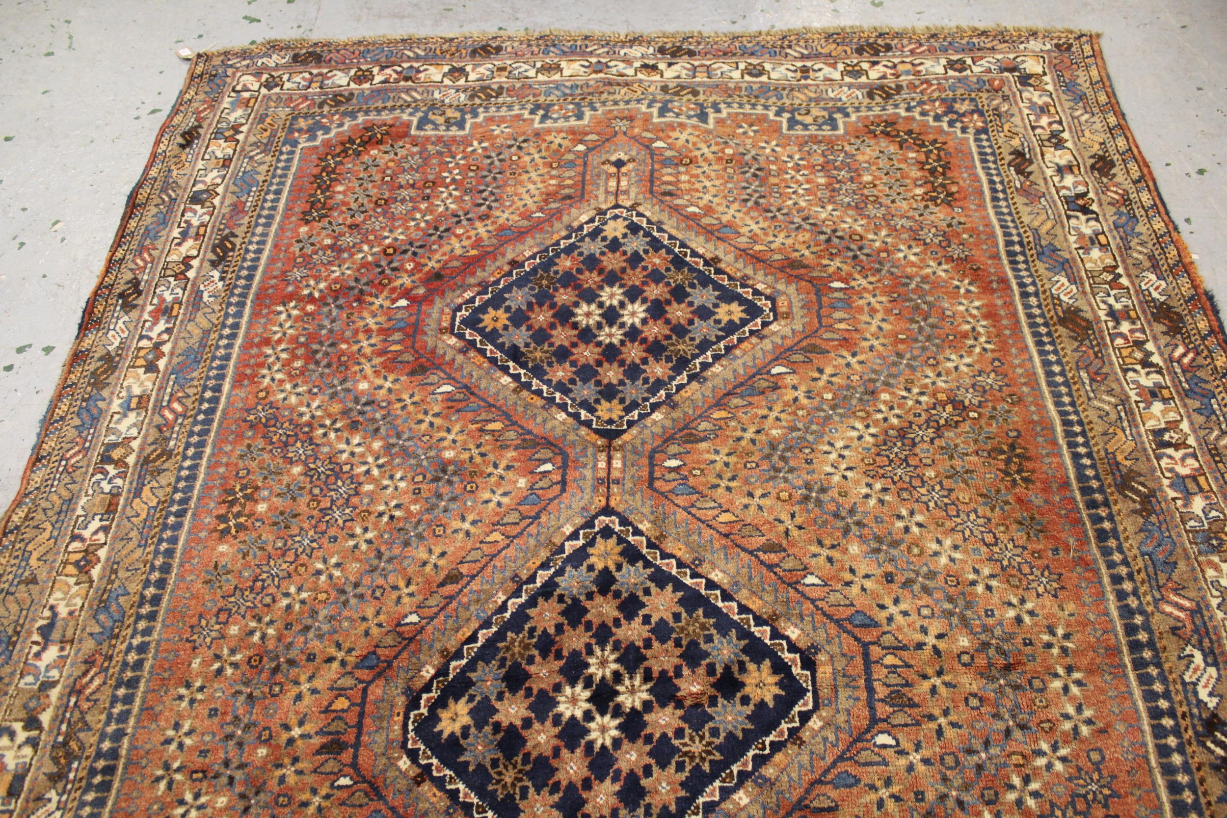 Small Shiraz carpet with a triple pole medallion design on a red ground with borders, 10ft - Image 3 of 4