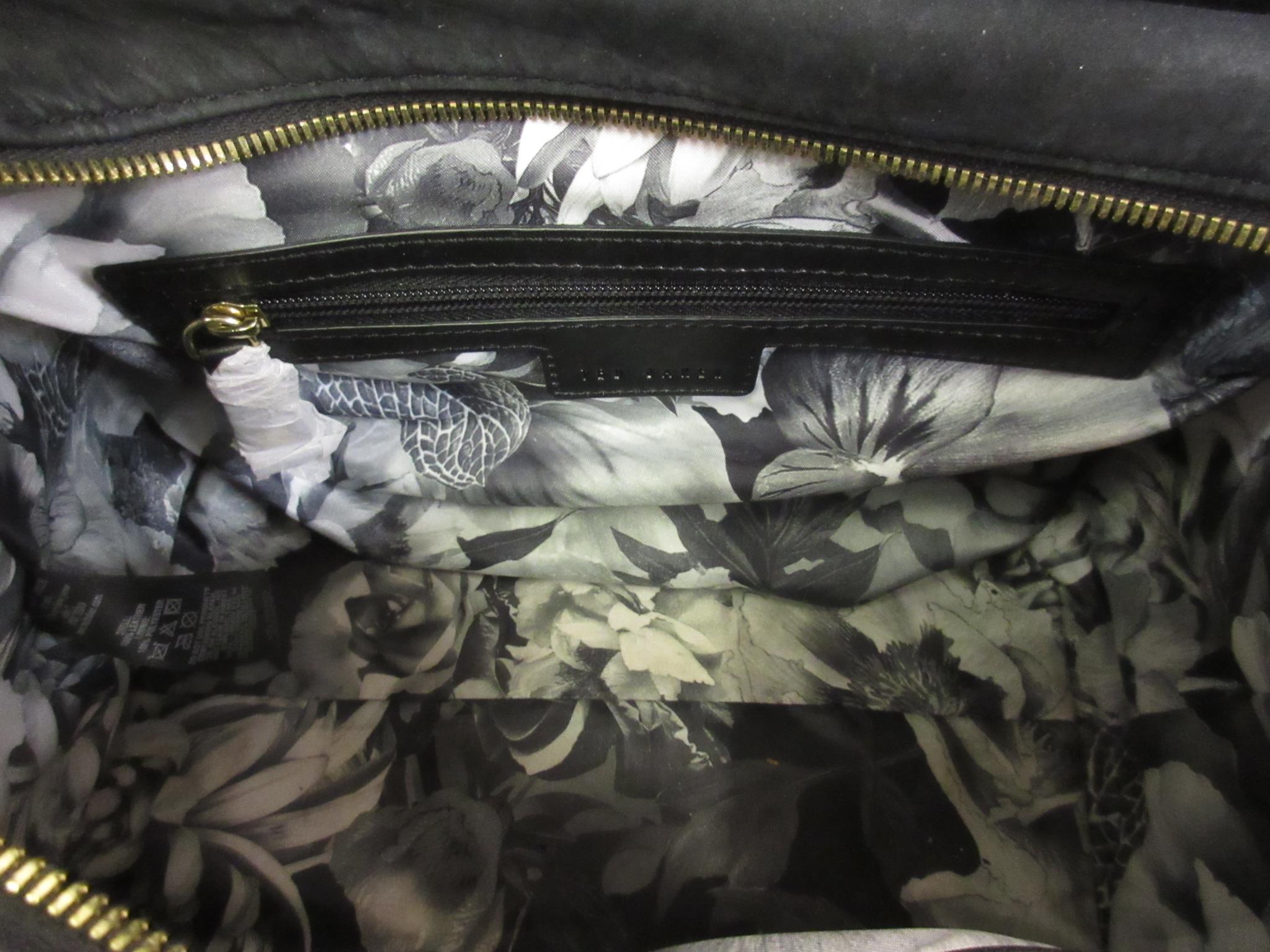 Ted Baker, gilt brass mounted black leather handbag, with dust bag This bag has been used but is - Image 3 of 6