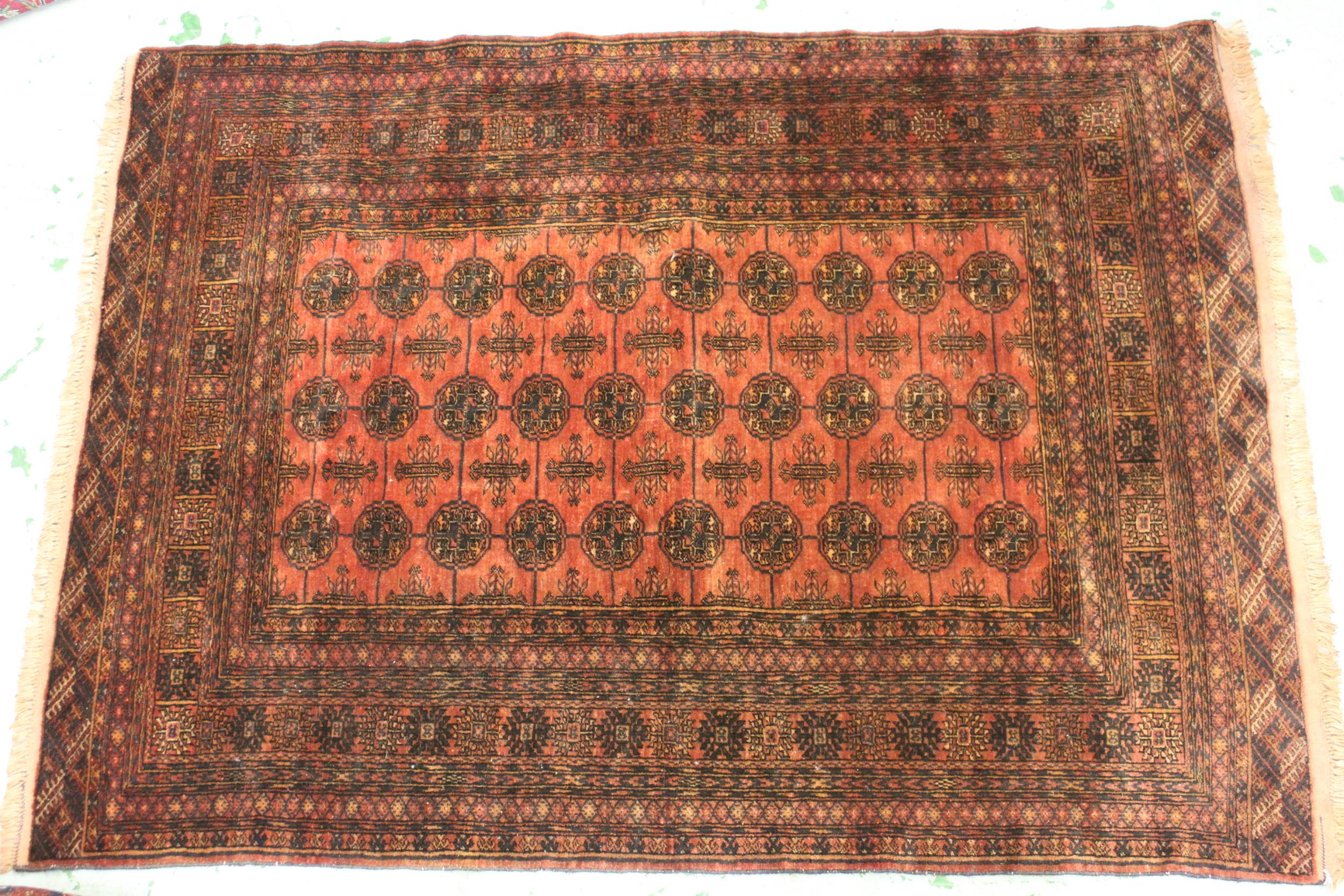 Modern Turkoman rug with three rows of ten gols on a wine ground, with multiple border, 6ft x 4ft