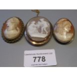 Oval 9ct gold mounted carved shell cameo brooch depicting a classical scene, together with two other