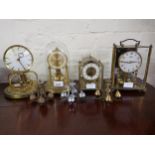 Small brass anniversary clock under glass dome, another by the same maker, lacking dome, two brass