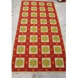 Flatweave woollen rug with an all-over panel design in shades of red, green and cream, 10ft 6ins x