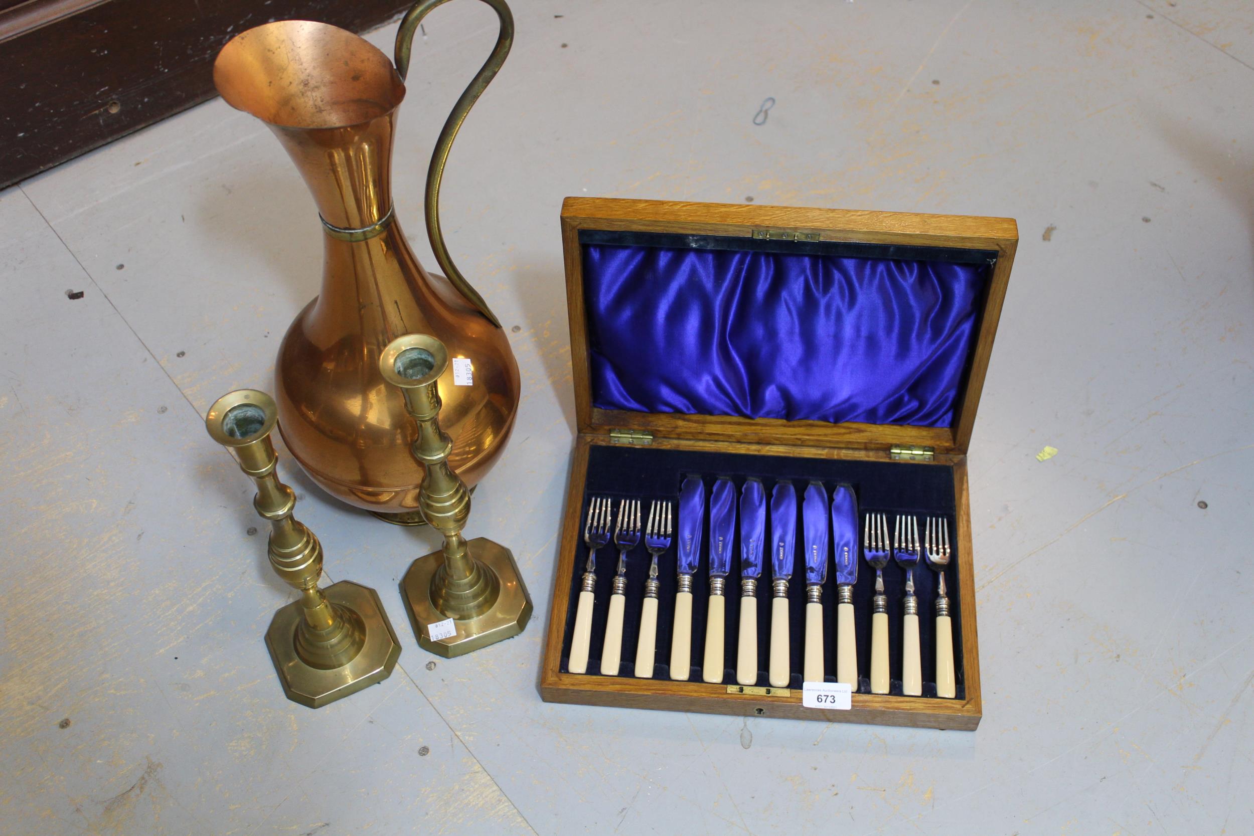 Oak cased six place set of fish knives and forks, pair of brass candlesticks and a copper jug