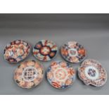 Two Imari iron red and blue decorated scallop shaped plates, together with four similar circular