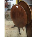 Oval mahogany tilt top pedestal table on turned column and tripod support