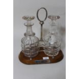 Edwardian oak and silver plate two bottle decanter stand with two glass decanters, together with a