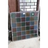 Seven leaded coloured glass window panels and another matching part panel (with some cracks),