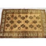 Small Afghan rug with an all over stylised floral design, in shades of beige and brown, 5ft4ins x