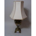 20th Century brass and porcelain table lamp painted with a musician figure