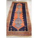 Large Hamadan rug with a triple pole medallion design on a brick red and midnight blue ground with