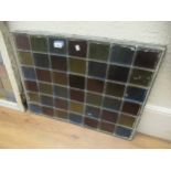 Six leaded and coloured glass window panels, (at fault), 27ins x 21ins and a part panel for coloured