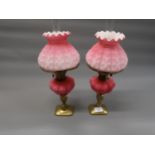 Pair of late 19th Century / early 20th Century pink opaque glass oil lamps, with matching shades and