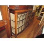 1920's mahogany bow fronted display cabinet, with two glazed doors, enclosing shelves and raised