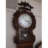 19th Century Continental oak longcase clock, the floral carved hood with a bar glazed pendulum