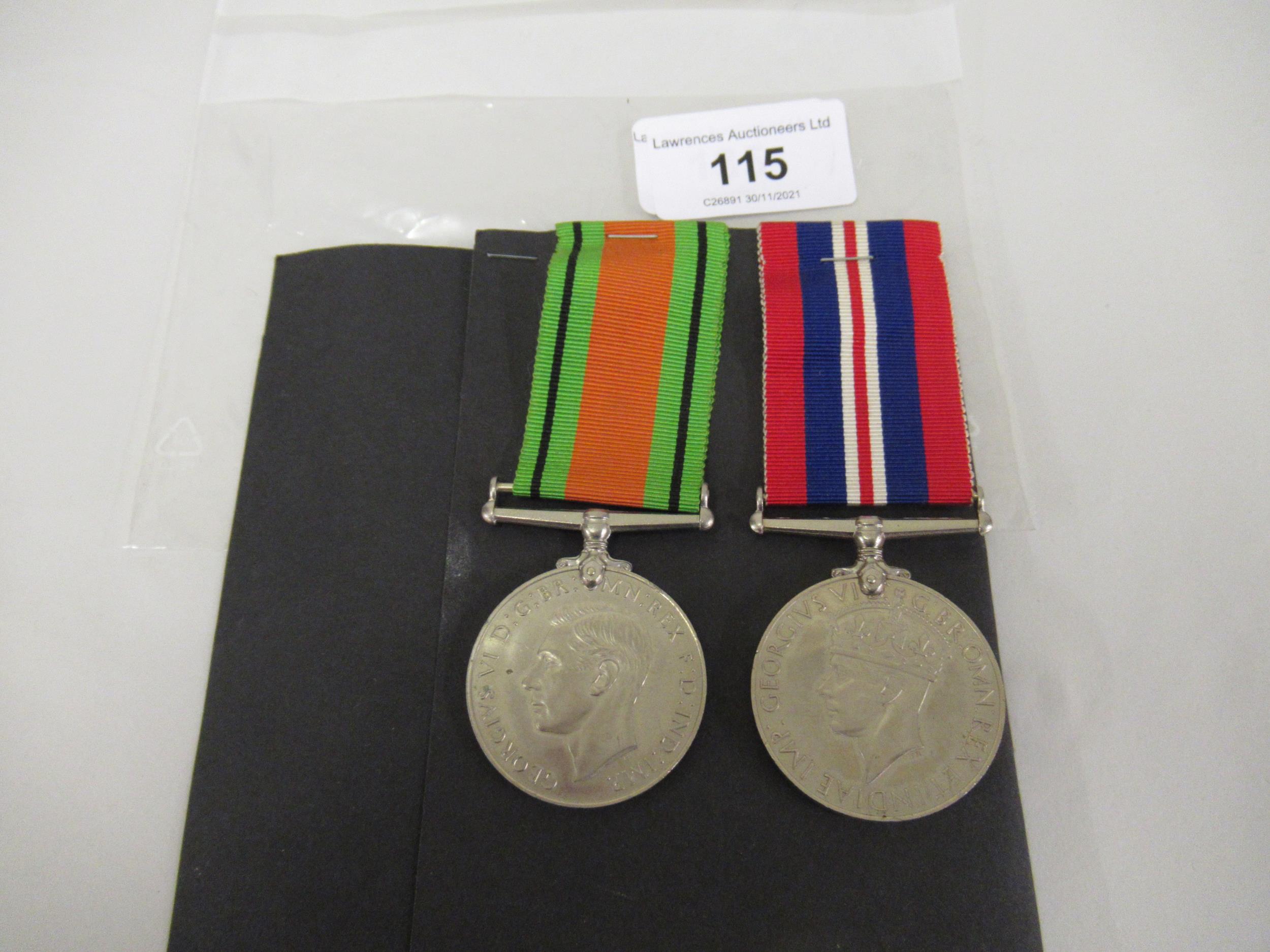 Two World War II medals on ribbons, mounted to a card