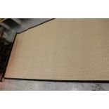 Large modern flat woven woollen carpet with a stitched black fabric border, 6m x 2.4m approximately