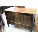 17th Century oak coffer with hinged cover, above a three panel carved front on stile supports, (with