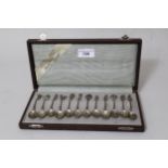Cased set of twelve Dutch silver coffee spoons, with embossed bowls and decorative finials