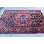 Zanjan rug with a medallion and all-over stylised design on a dark ground with borders, 2.06m x 1.4m