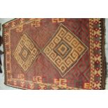 Kelim carpet with a twin medallion and all over stylised stepped and hooked design, on a red