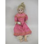 German Heubach bisque headed doll with sleeping eyes, open mouth and four teeth on a jointed