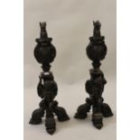 Pair of large dark patinated bronze firedogs, each in the form of a gryphons head above an