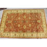 Pakistan Ziegler rug with an all over palmette design on a brick red field, with ivory borders,